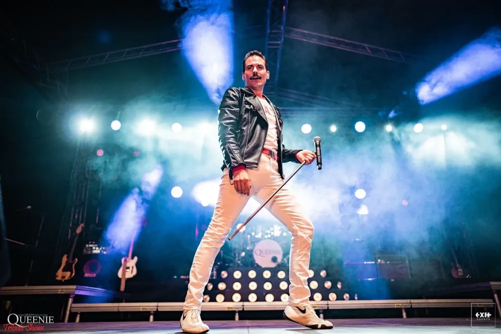 Queen tribute performer playing to a live audience
